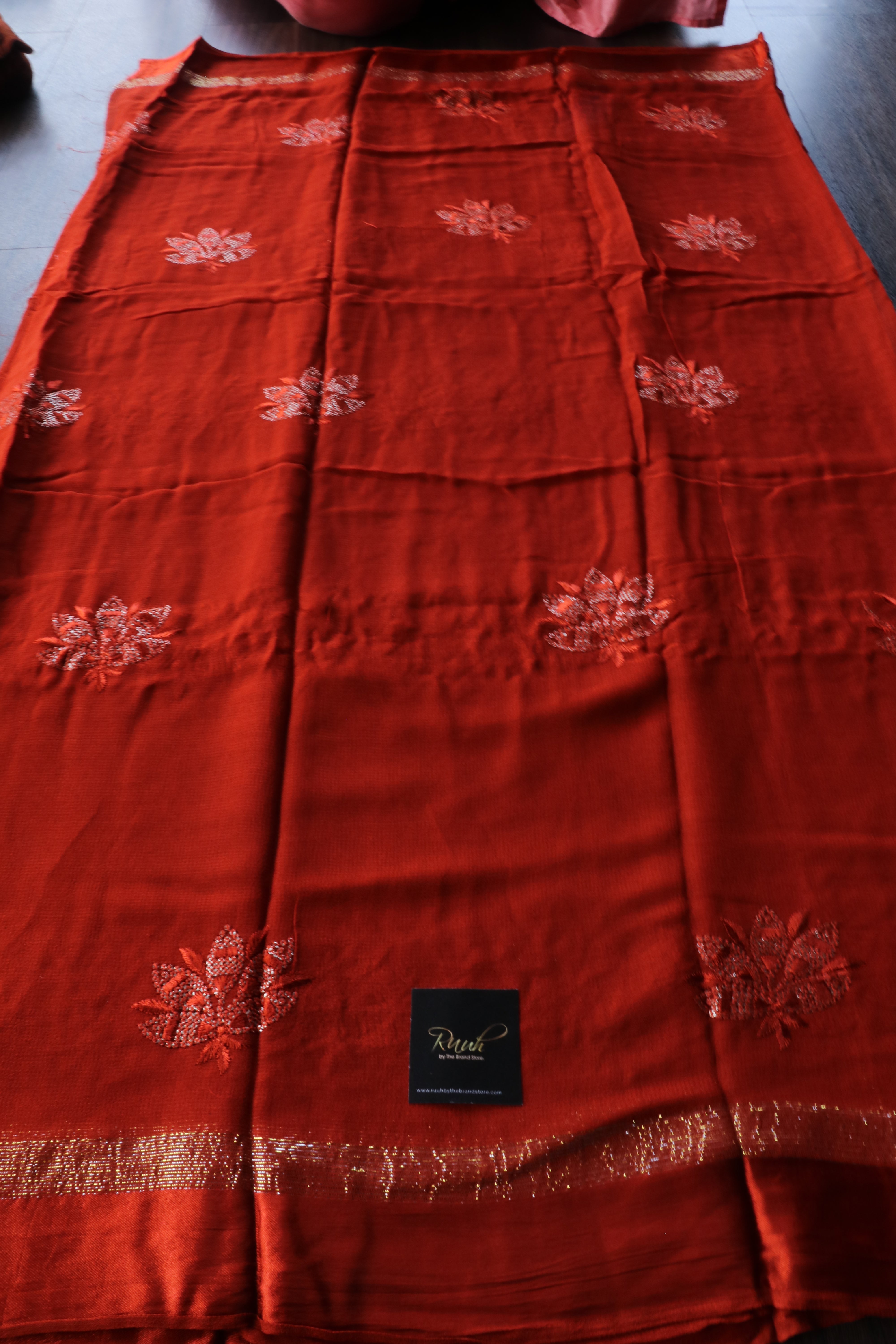 RUST ORANGE VISCOSE GEORGETTE SAREE WITH LOTUS EMBROIDERY