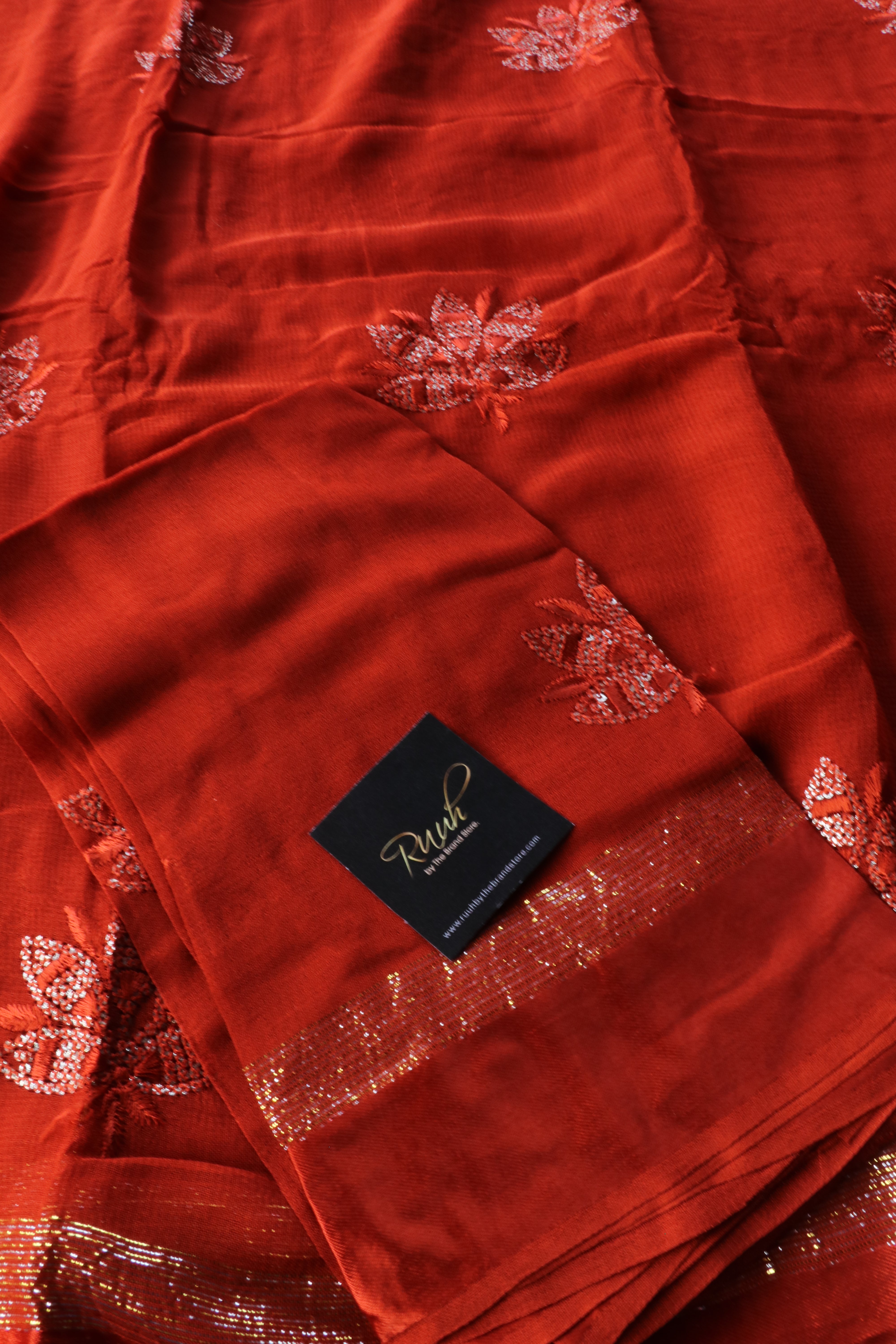 RUST ORANGE VISCOSE GEORGETTE SAREE WITH LOTUS EMBROIDERY