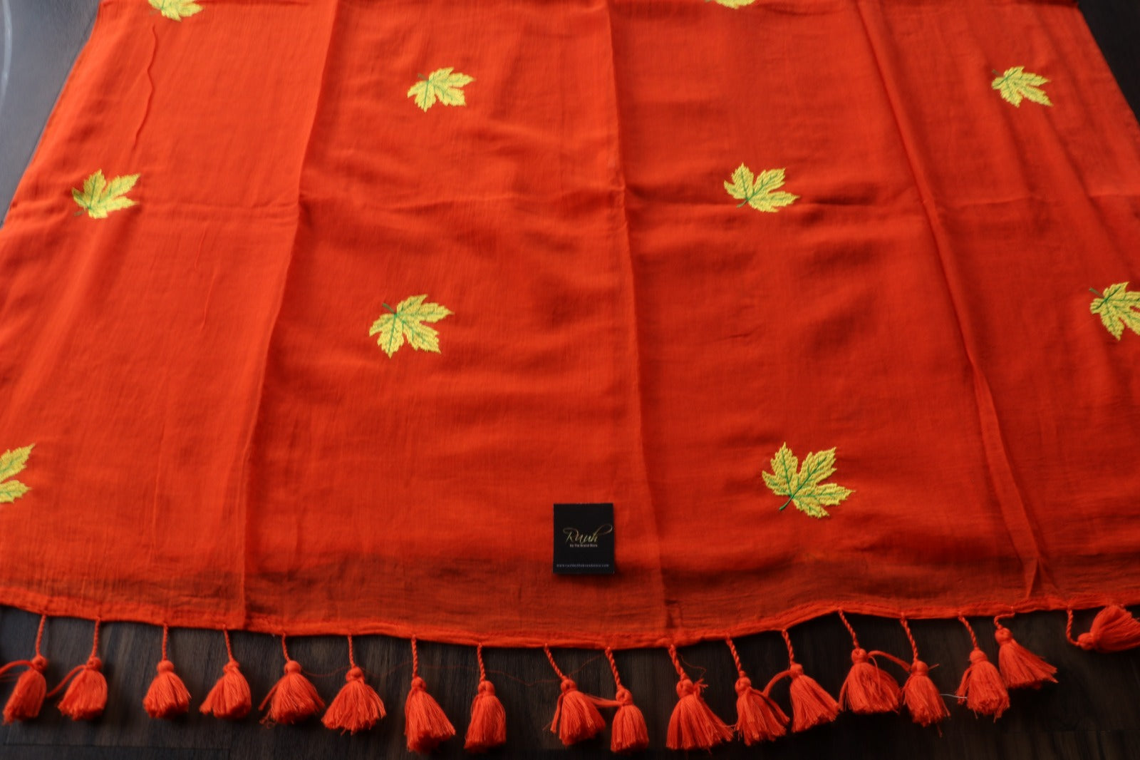 ORANGE MULMUL SAREE WITH MAPLE LEAF EMBROIDERY