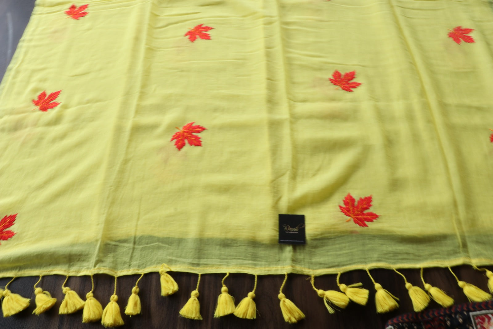 YELLOW MULMUL SAREE WITH MAPLE LEAF EMBROIDERY