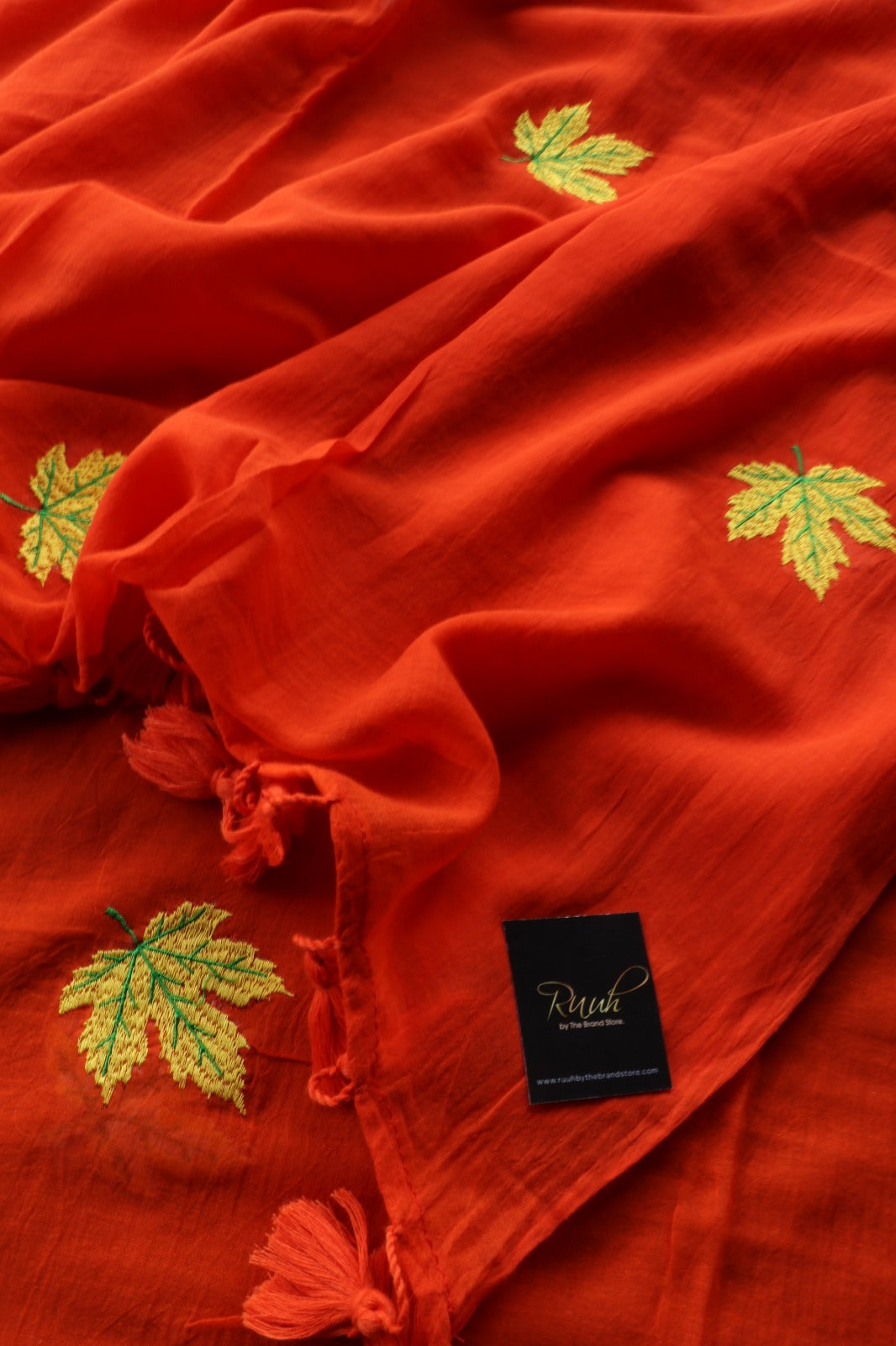 ORANGE MULMUL SAREE WITH MAPLE LEAF EMBROIDERY