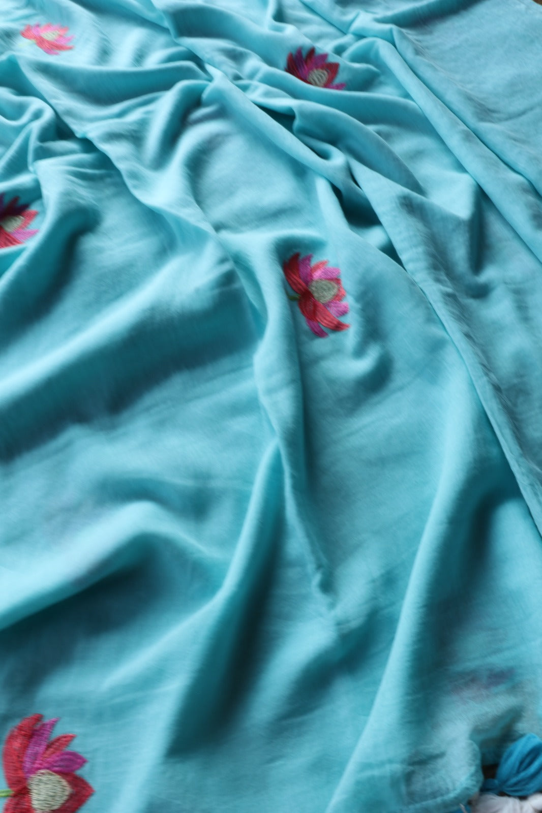 LIGHT BLUE MULMUL SAREE WITH LOTUS EMBROIDERY