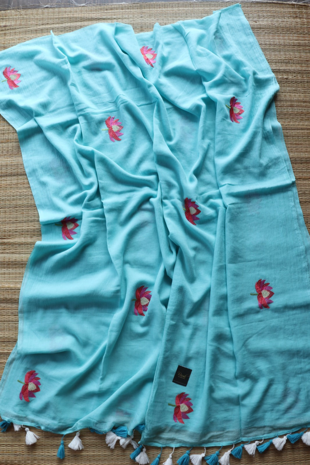 LIGHT BLUE MULMUL SAREE WITH LOTUS EMBROIDERY